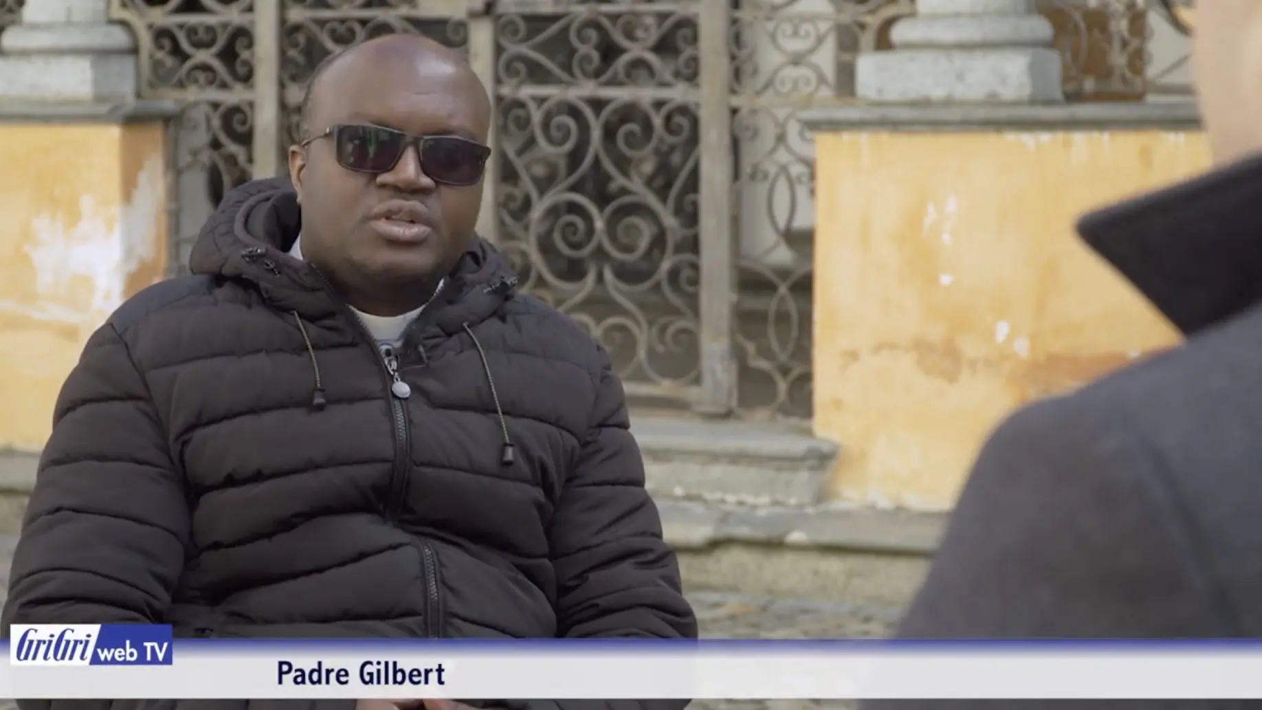 Fotografia di Padre Gilbert mentre discorre concentrato ma abilmente con Antonio Platz